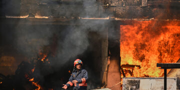 Fire officials douse a fire at a residential complex that houses Indian lawmakers, in New Delhi, India, Saturday, Oct. 18, 2025. (AP Photo)