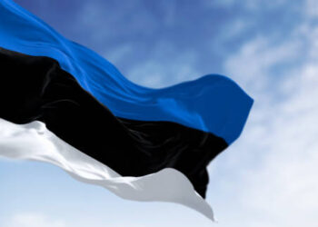 National flag of Estonia waving in the wind n a clear day. horizontal tricolor featuring three equal bands of blue, black and white. 3d illustration render. Selective focus. Fluttering fabric