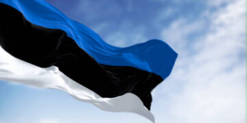 National flag of Estonia waving in the wind n a clear day. horizontal tricolor featuring three equal bands of blue, black and white. 3d illustration render. Selective focus. Fluttering fabric