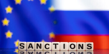 FILE PHOTO: Plastic letters arranged to read "Sanctions" are placed in front of EU and Russia's flag colors in this illustration taken February 25, 2022. REUTERS/Dado Ruvic/Illustration